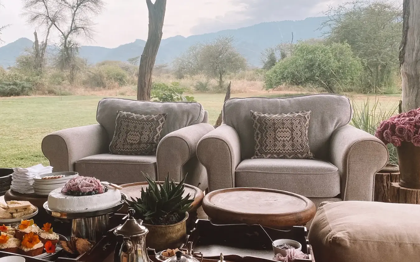 Outdoor lounge seating overlooking savanna landscape and mountains, Kalepo Camp, Northern Kenya, Kenya