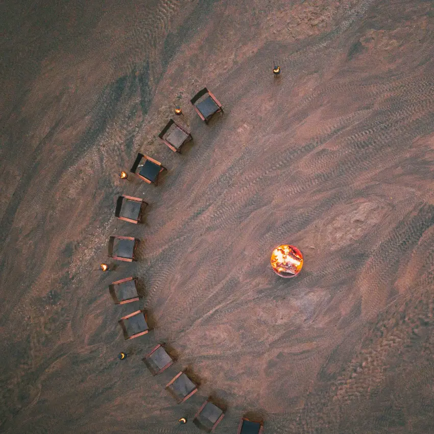 Aerial view of safari camp with arranged structures and vehicle, Northern Kenya, Kenya