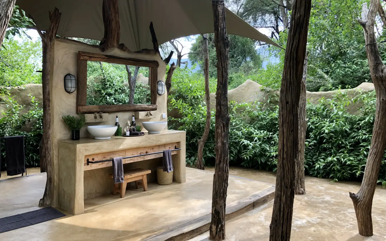 Outdoor bathroom with dual vessel sinks under canvas canopy, Kalepo Camp, Northern Kenya, Kenya