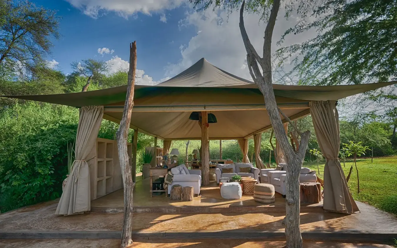 Canvas lounge pavilion with natural tree posts and seating, Kalepo Camp, Northern Kenya, Kenya