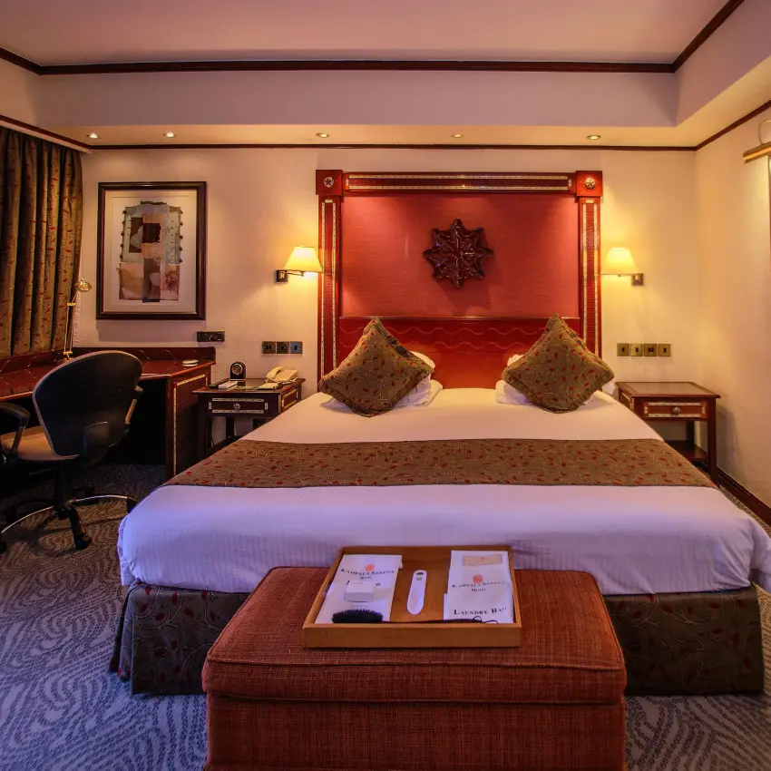 Luxury hotel bedroom with red velvet headboard and gold accents, Kampala Serena Hotel, Entebbe and Kampala, Uganda