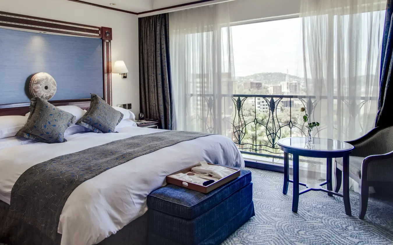 Luxury hotel bedroom with balcony overlooking city and hills, Kampala Serena Hotel, Entebbe and Kampala, Uganda
