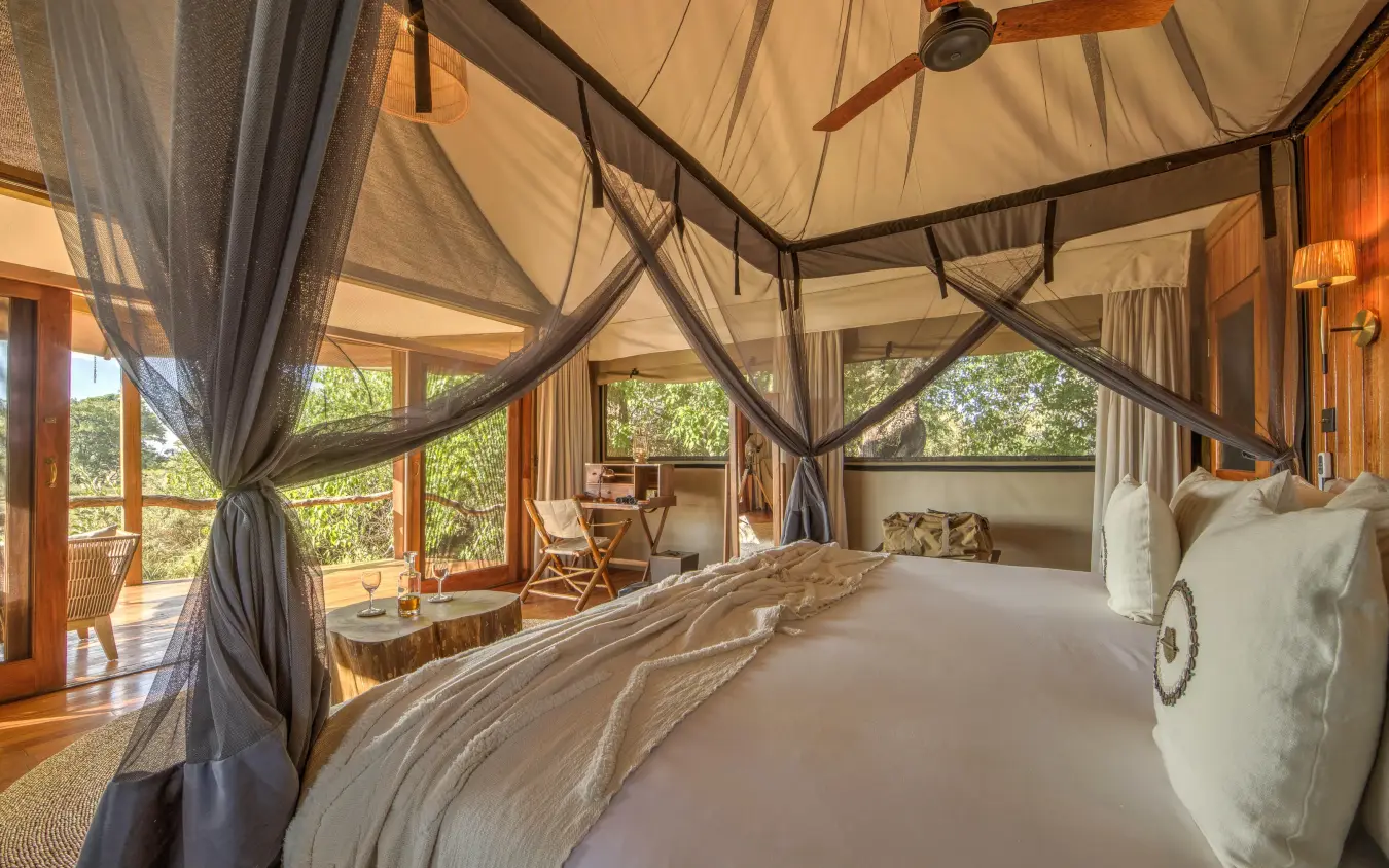 Luxury bedroom with sheer canopy bed and forest views, Kanana, The Okavango Delta, Botswana