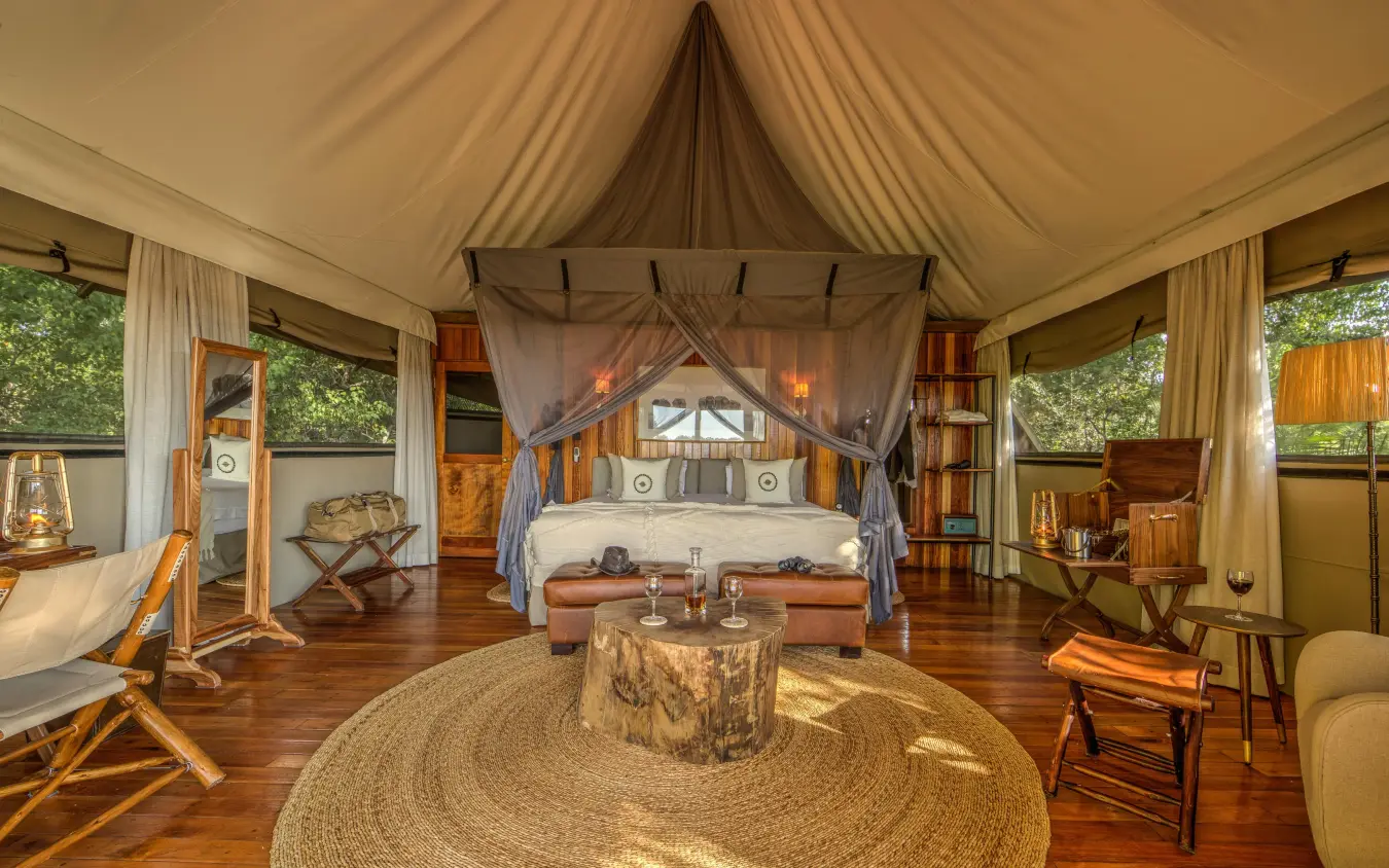 Luxury safari tent bedroom with four-poster bed and canvas interior, Kanana, The Okavango Delta, Botswana