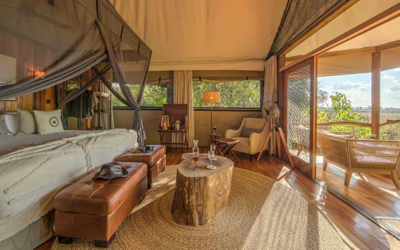 Luxury safari tent interior with bed and lounge seating, Kanana, The Okavango Delta, Botswana