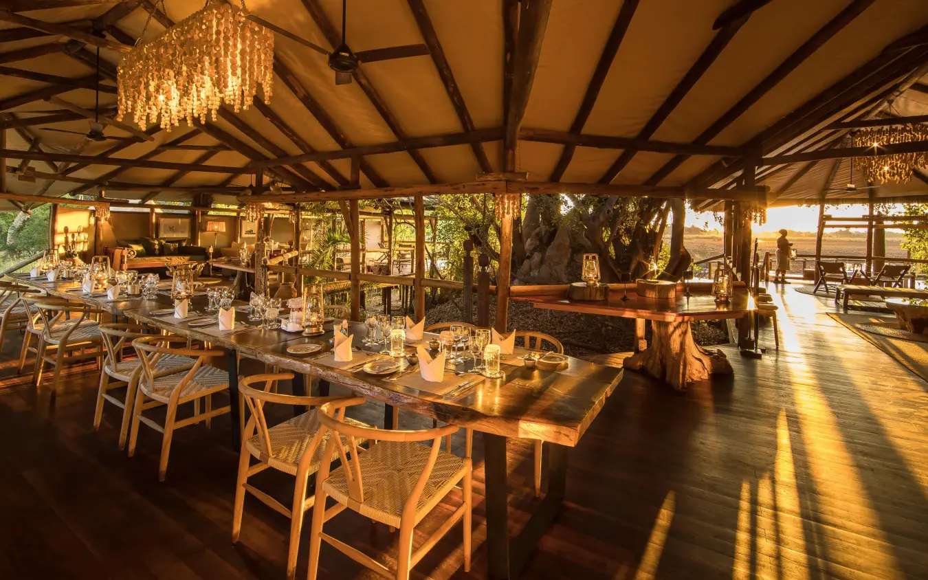 Open-air dining pavilion with wooden beams and chandeliers, Kanana, The Okavango Delta, Botswana