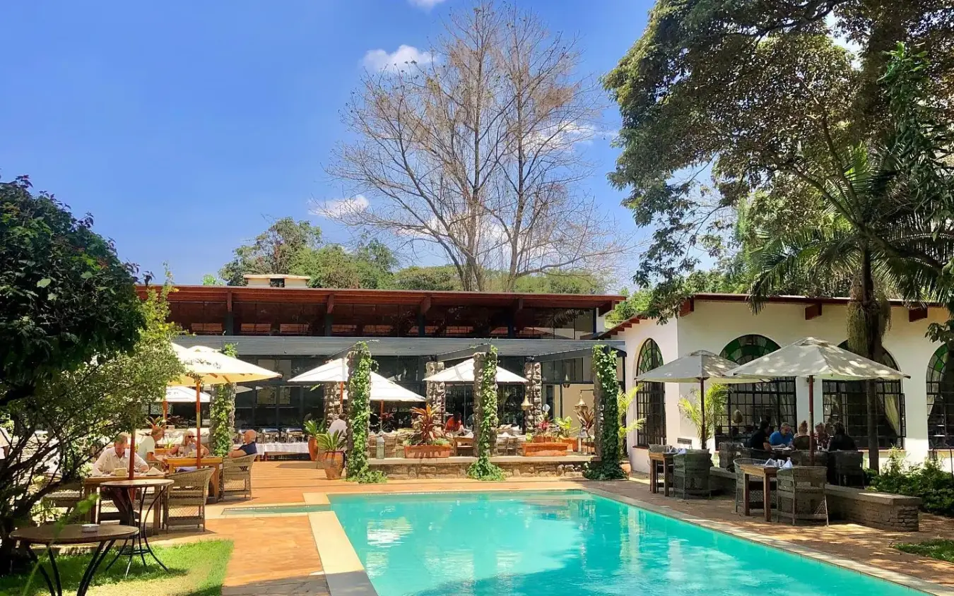 Luxury lodge with swimming pool and covered terrace among trees, Karen Blixen Cottages, Nairobi, Kenya
