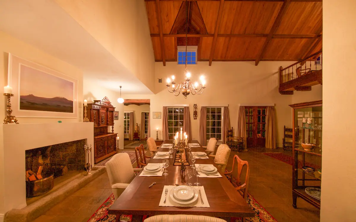 Formal dining room with long wooden table set for guests, Karen Gables, Nairobi, Kenya