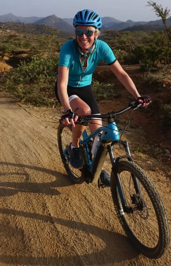 Mountain biker on dirt trail in arid landscape, Karisia Walking Safaris, Laikipia Highlands, Kenya
