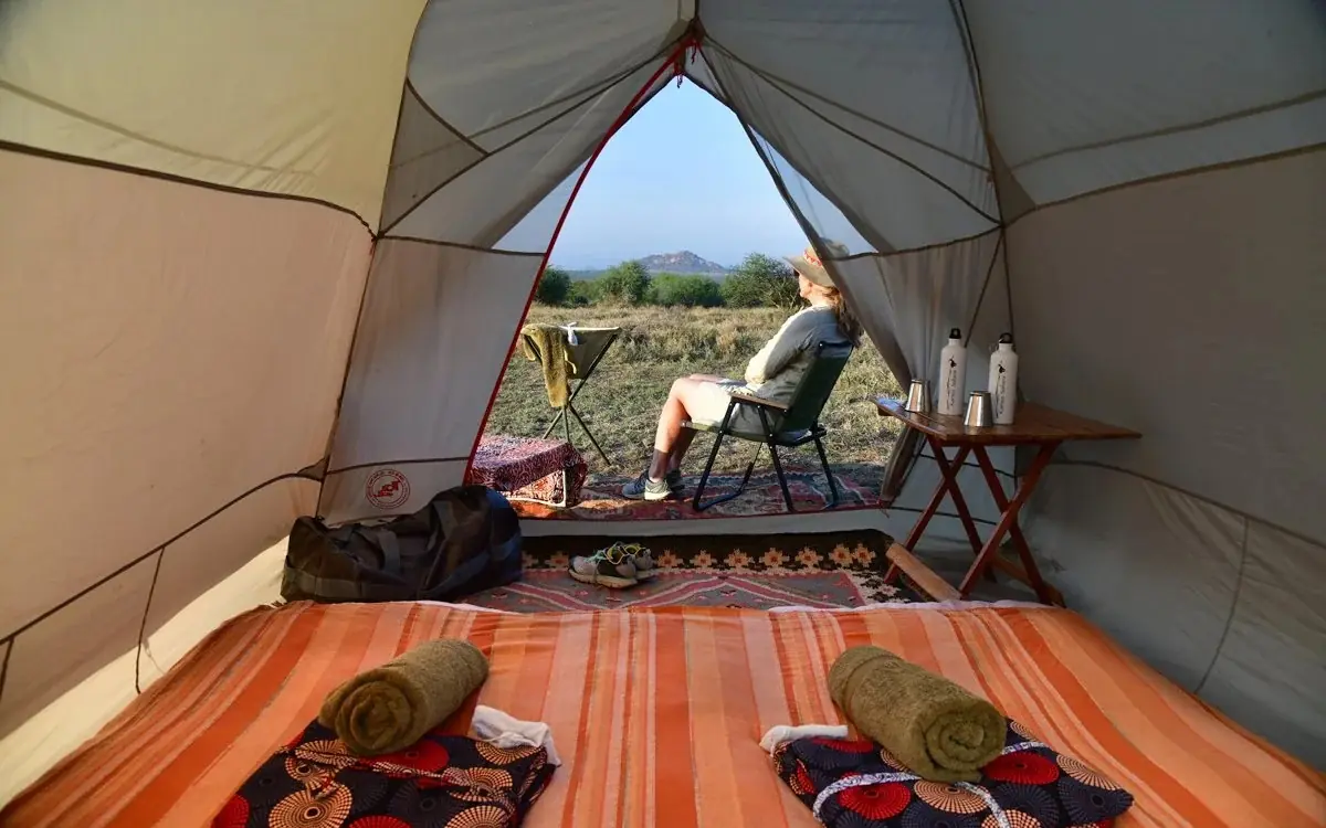 Interior view of safari tent with two beds and open entrance, Karisia Walking Safaris, Laikipia Highlands, Kenya