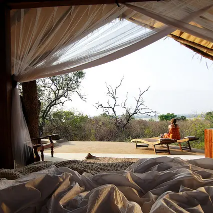 Open-air safari lodge pavilion with day beds overlooking savanna landscape, Kiba Point, Nyerere National Park, Tanzania