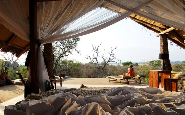 Open-air safari lodge pavilion with day beds overlooking savanna landscape, Kiba Point, Nyerere National Park, Tanzania