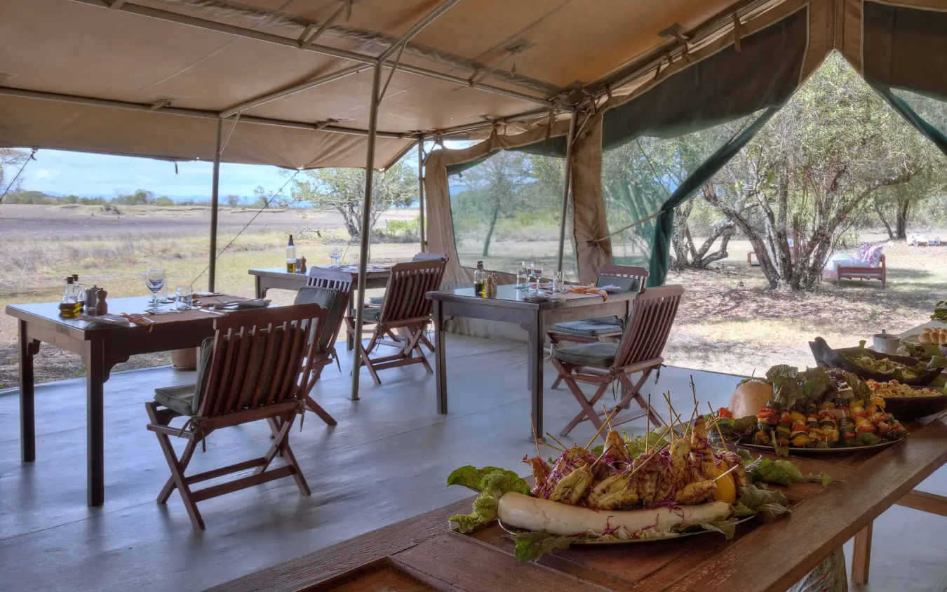 Safari camp dining setup with plated food and open views, Kicheche Bush Olare, Maasai Mara, Kenya