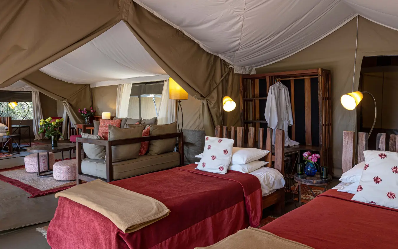 Luxurious tent bedroom with red bedding and canvas walls, Kicheche Bush Olare, Maasai Mara, Kenya