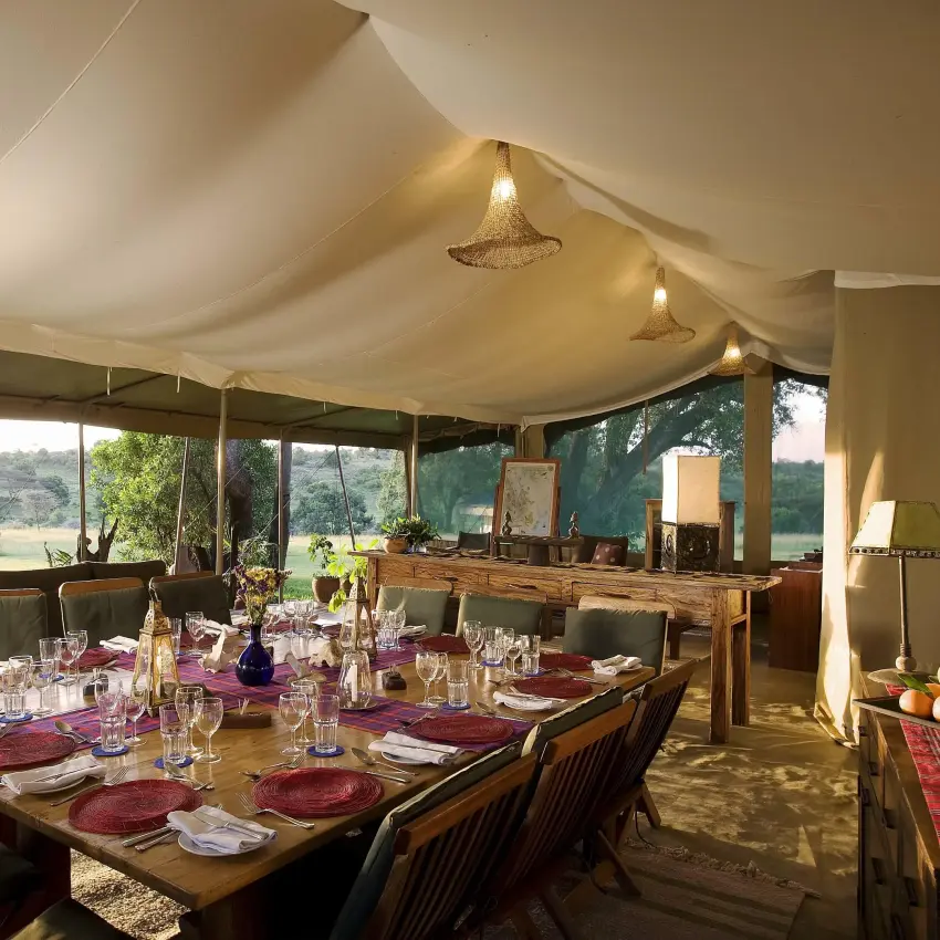 Safari tent dining room with set table and landscape views, Kicheche Mara North, Maasai Mara, Kenya