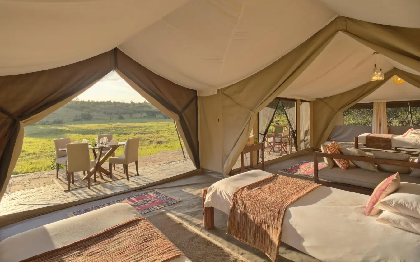 Spacious safari tent bedroom with savanna views through open canvas, Kicheche Mara North, Maasai Mara, Kenya