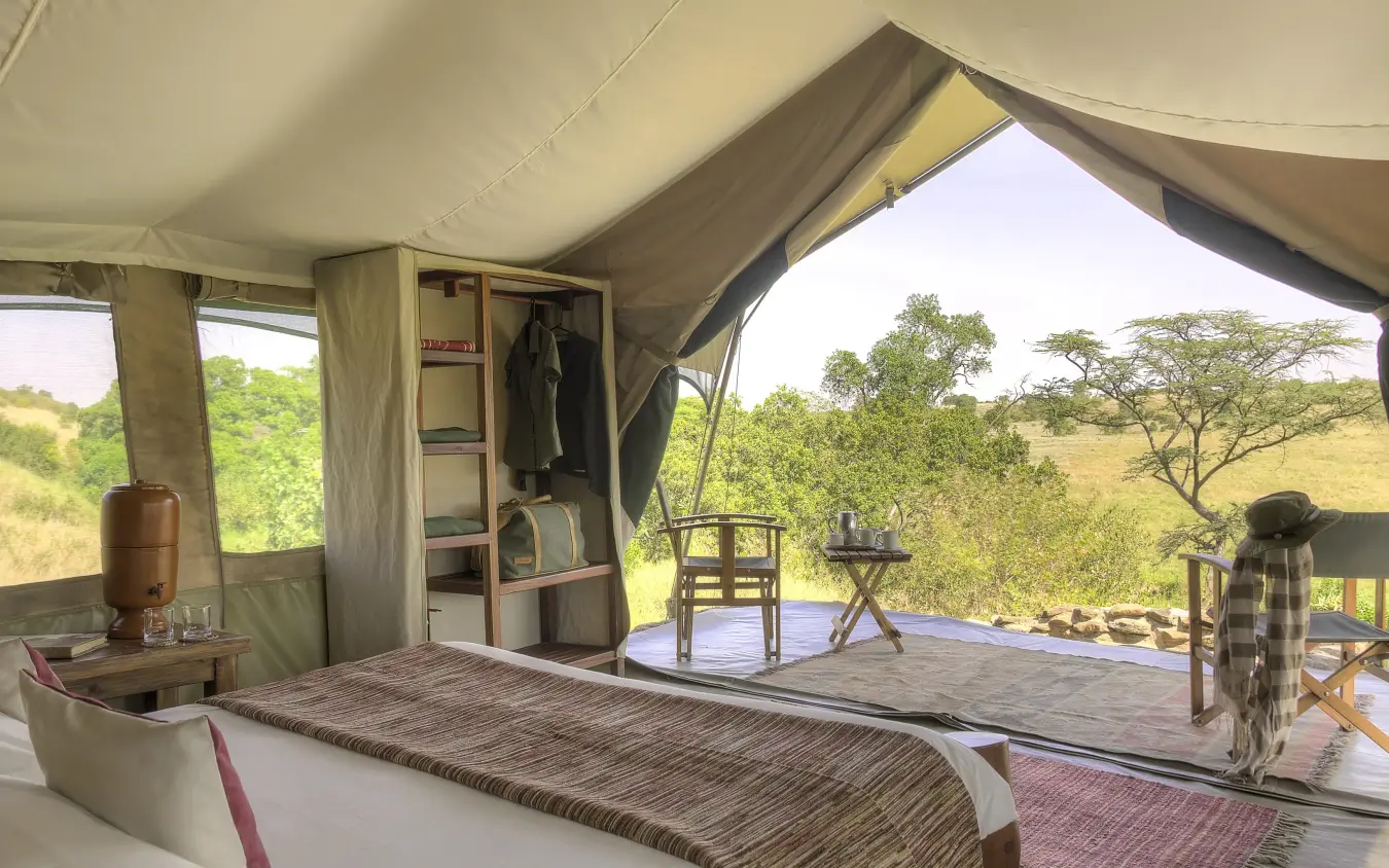 Safari tent bedroom with views of acacia trees and savanna, Kicheche Mara North, Maasai Mara, Kenya