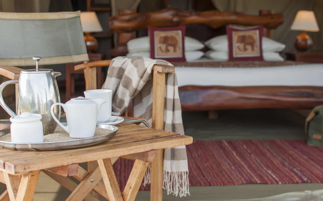 Tea service with white pottery on wooden table indoors, Kicheche Mara North, Maasai Mara, Kenya