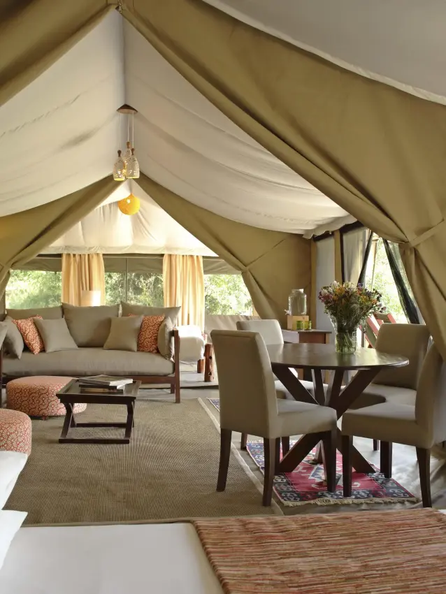 Luxury safari tent interior with seating and dining area, Kicheche Mara North, Maasai Mara, Kenya
