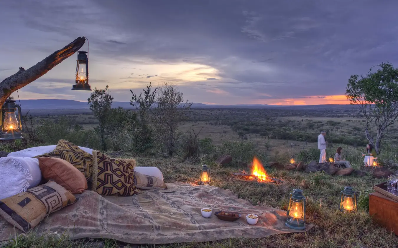 Twilight campsite with lanterns overlooking savanna landscape, Kicheche Valley Naboisho, Maasai Mara, Kenya