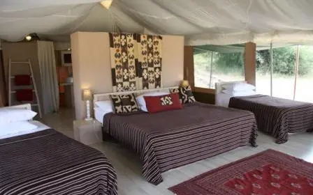 Spacious safari bedroom with multiple beds and large windows, Kicheche Valley Naboisho, Maasai Mara, Kenya
