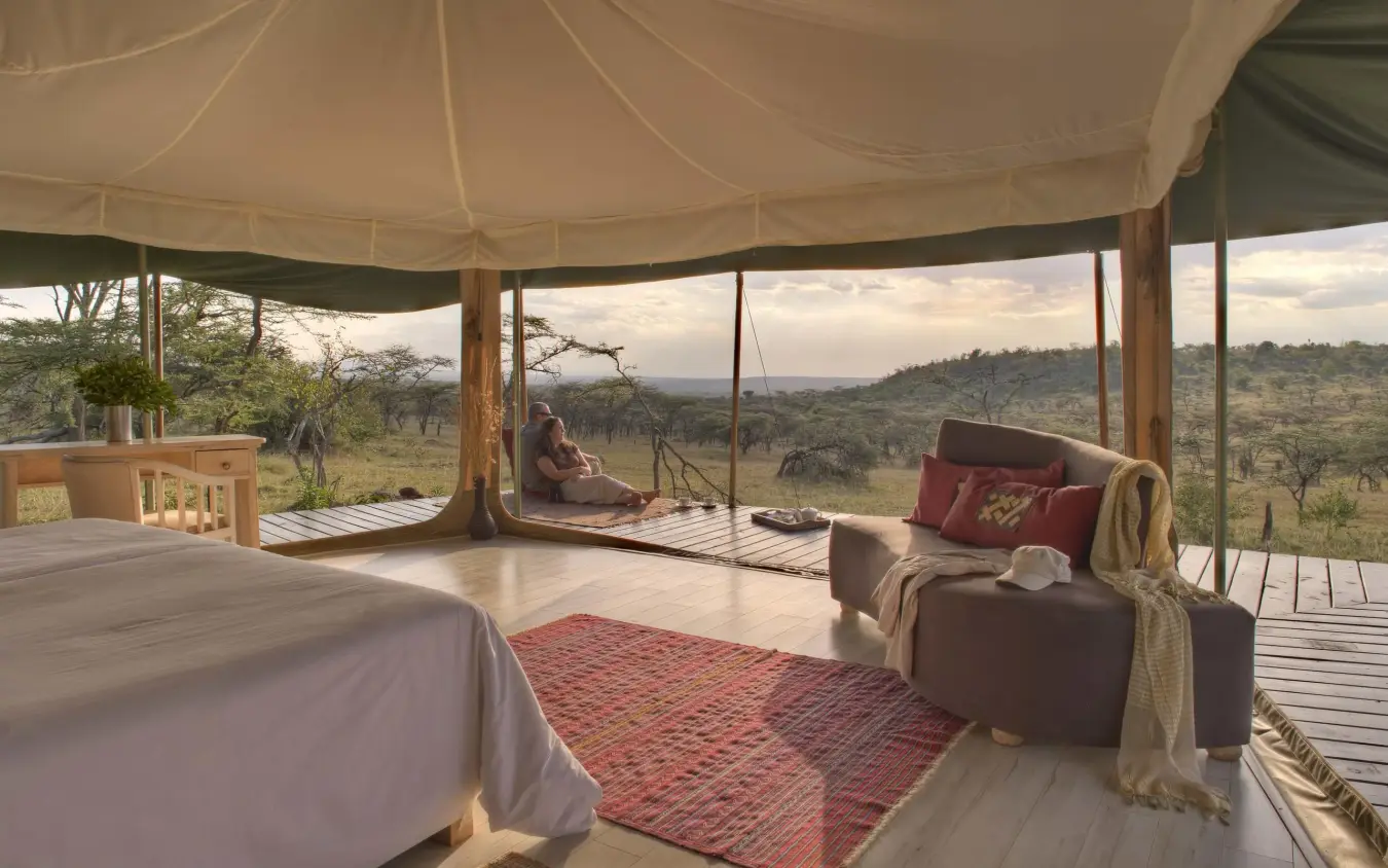 Bedroom interior with expansive views of African savanna landscape, Kicheche Valley Naboisho, Maasai Mara, Kenya