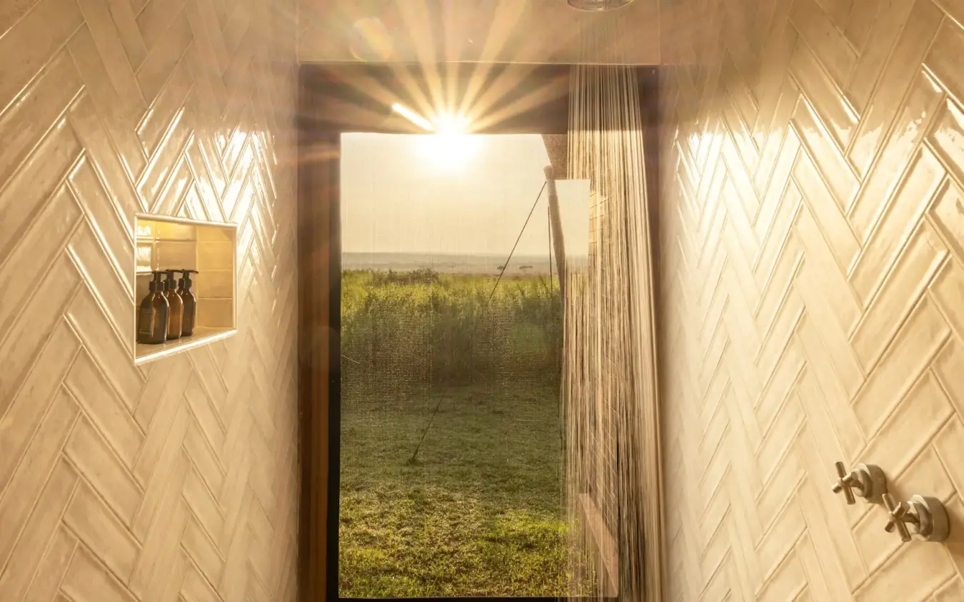 Minimalist bathroom interior with view of vast grassland at sunset, Kichwa Tembo Tented Camp, Maasai Mara, Kenya