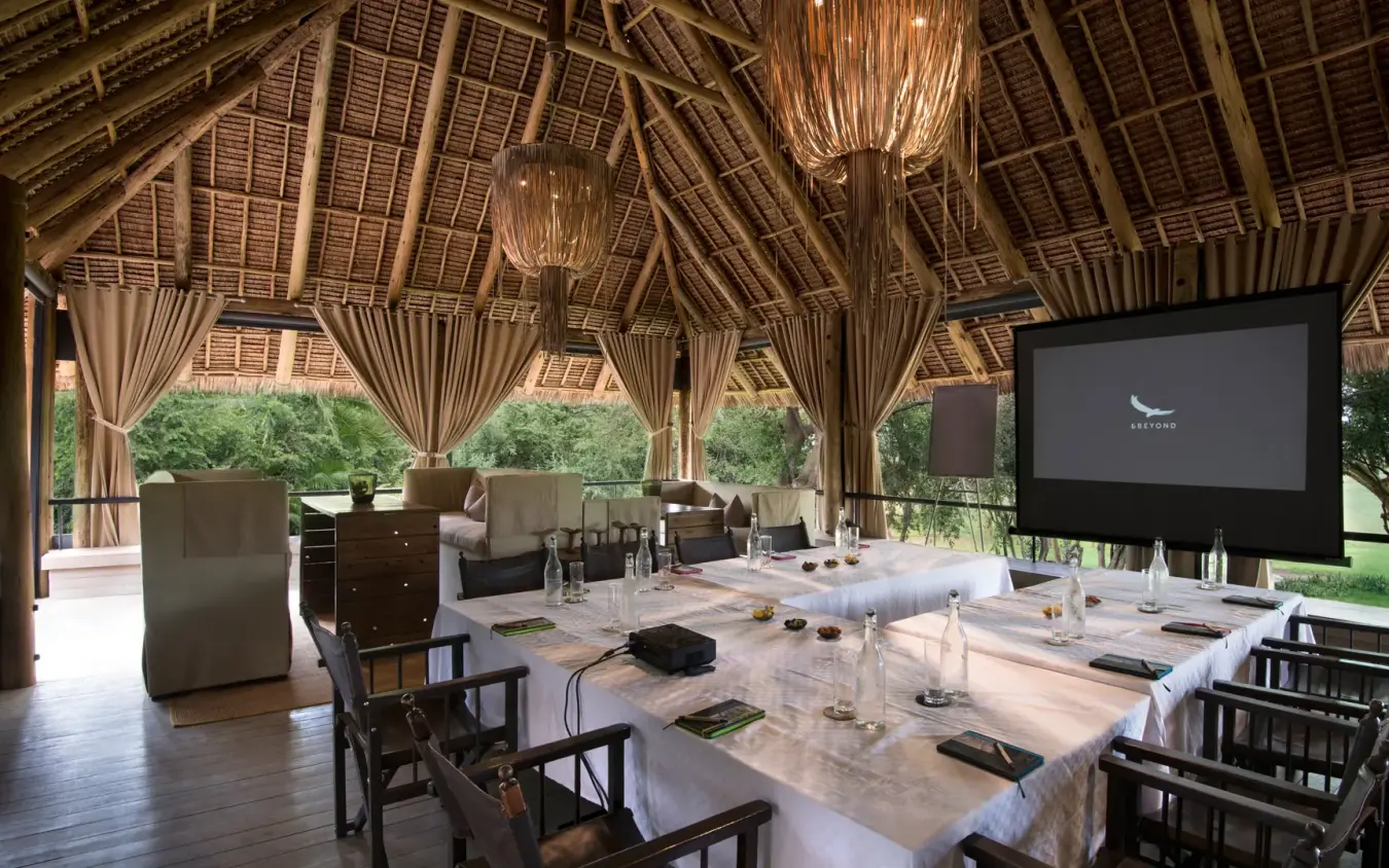 Open-air pavilion with conference table and projection screen overlooking gardens, Kichwa Tembo Tented Camp, Maasai Mara, Kenya