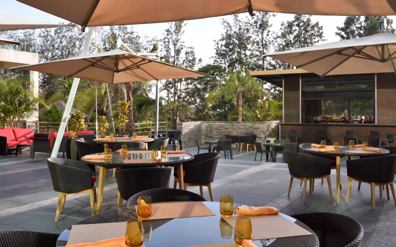 Outdoor dining terrace with umbrellas overlooking gardens, Kigali Marriott Hotel, Kigali, Rwanda