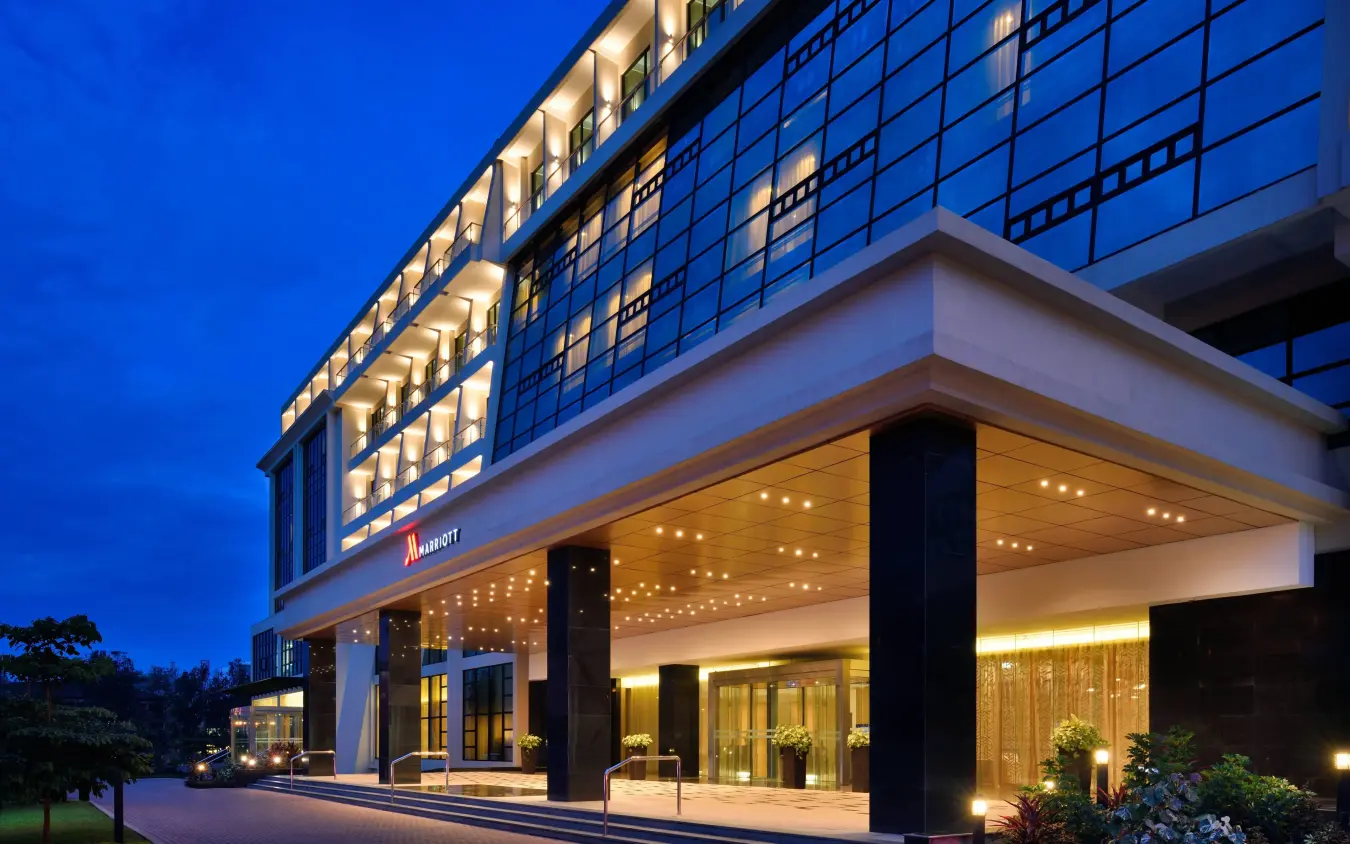 Modern hotel exterior illuminated at dusk with entrance, Kigali Marriott Hotel, Kigali, Rwanda