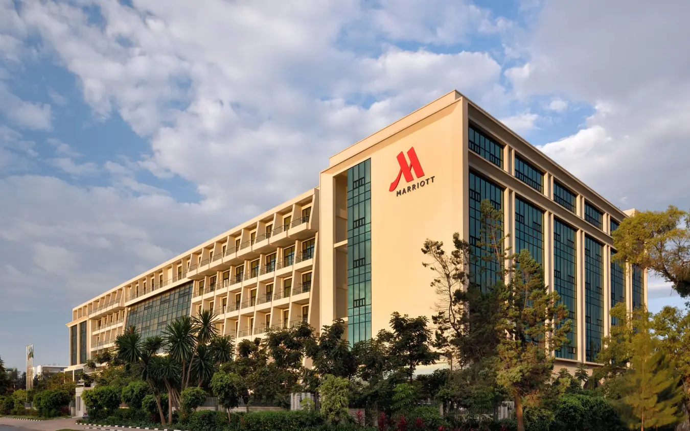 Modern hotel building with cream facade and red logo, Kigali Marriott Hotel, Kigali, Rwanda
