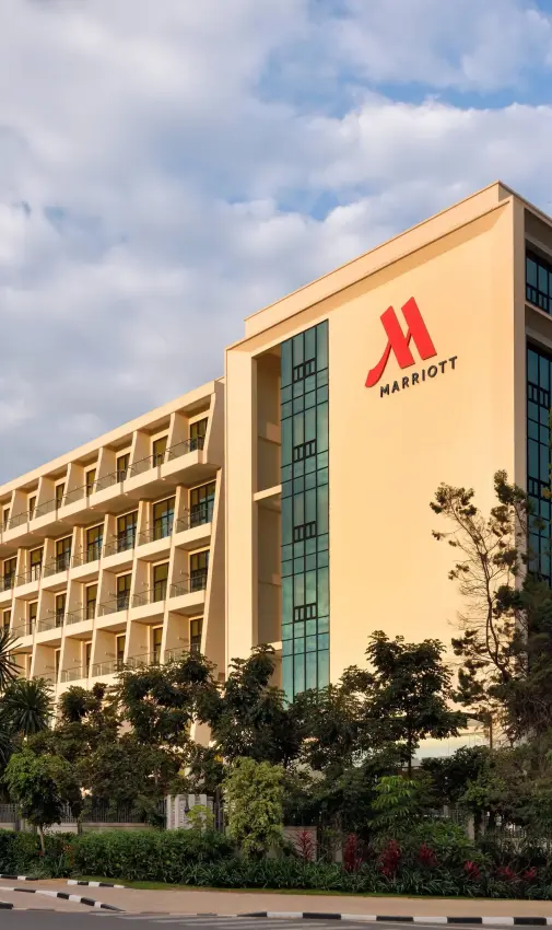Modern hotel building with cream facade and red logo, Kigali Marriott Hotel, Kigali, Rwanda