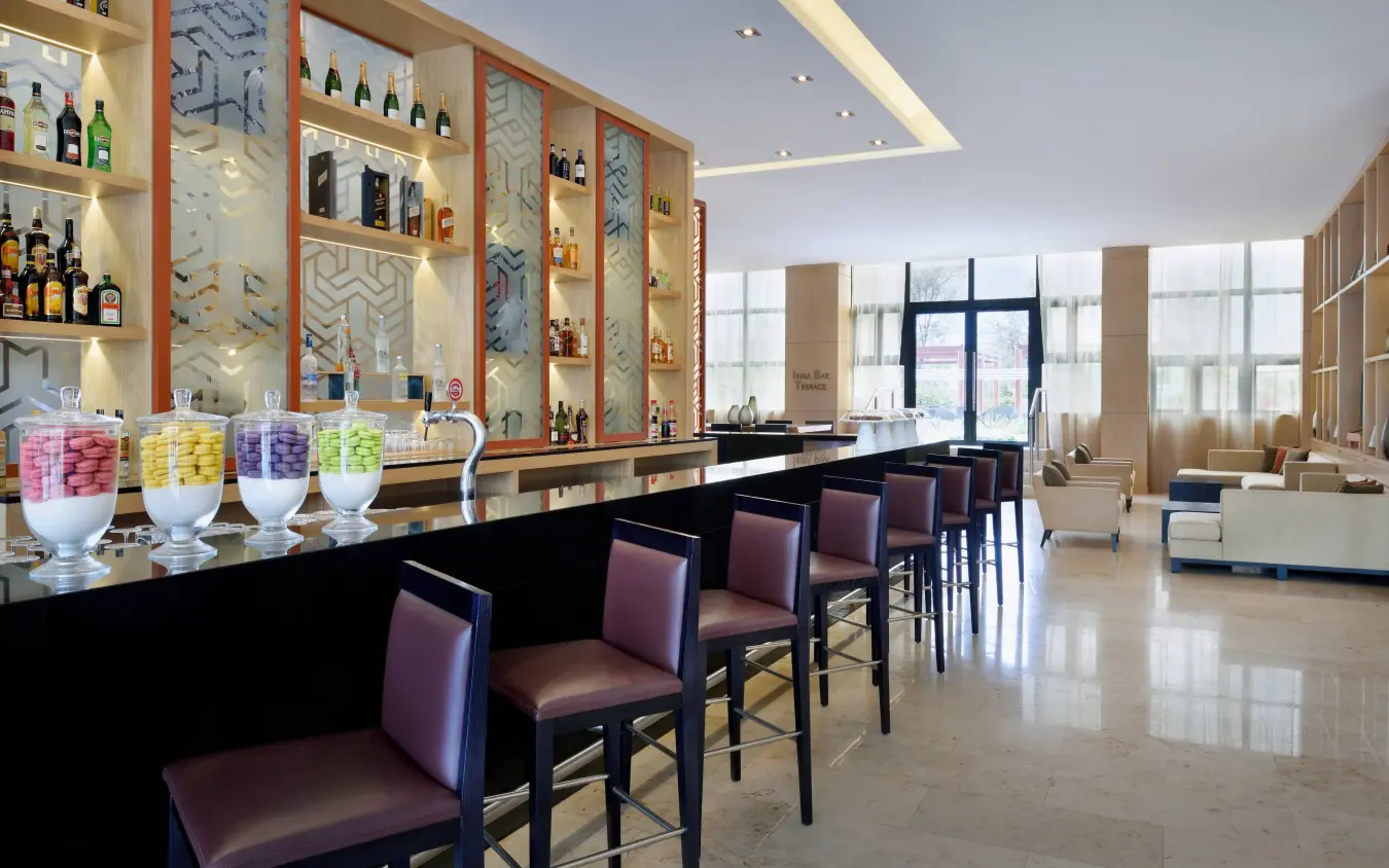 Modern bar and lounge area with colorful beverages and seating, Kigali Marriott Hotel, Kigali, Rwanda
