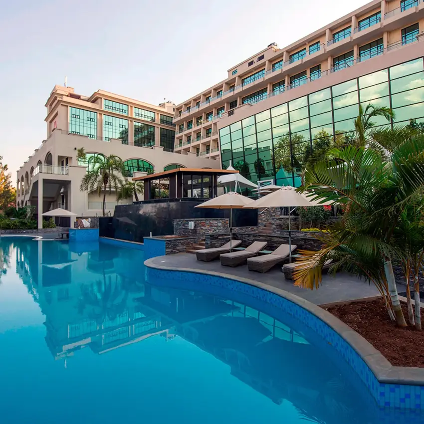 Curved swimming pool with loungers and hotel building, Kigali Marriott Hotel, Kigali, Rwanda