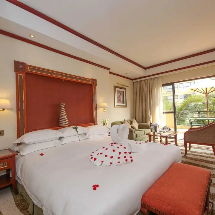 Luxury bedroom with red headboard and balcony view, Kigali Serena Hotel, Kigali, Rwanda