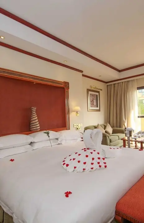 Luxury bedroom with red headboard and balcony view, Kigali Serena Hotel, Kigali, Rwanda