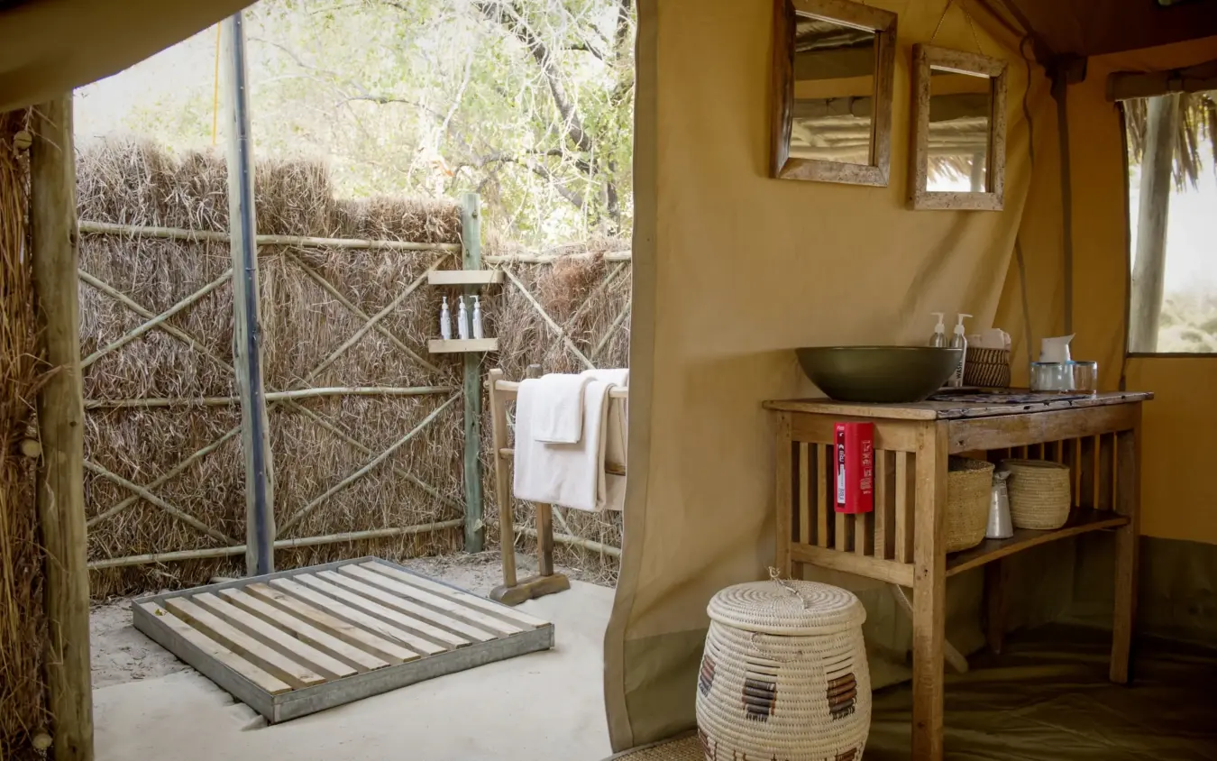 Outdoor bathroom with sink, mirror, and wooden shower enclosure, Kigelia Ruaha, Ruaha National Park, Tanzania