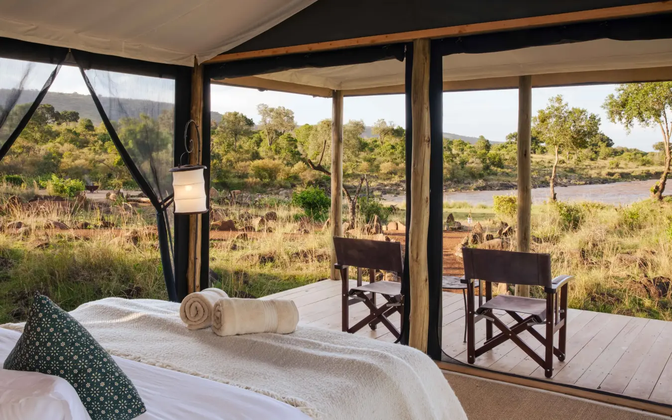 Bedroom with river and savanna views through open windows, Serian Kimya Kimya, Maasai Mara, Kenya