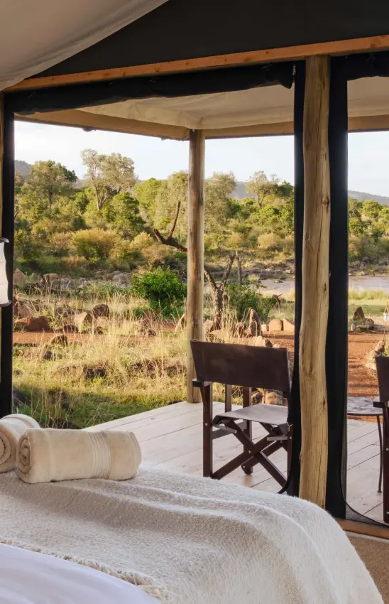 Bedroom with river and savanna views through open windows, Serian Kimya Kimya, Maasai Mara, Kenya