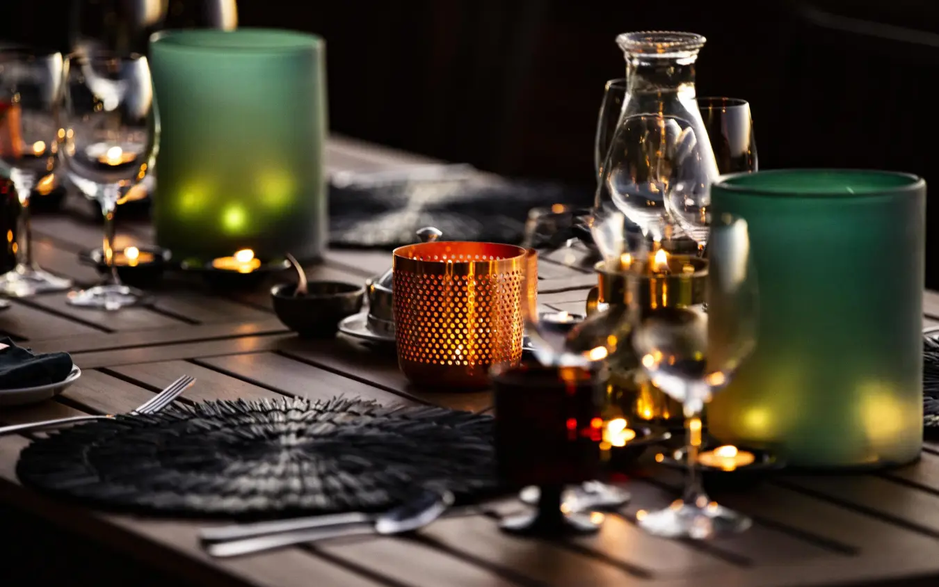 Elegant table setting with candles and glassware at night, King’s Pool, Linyanti Wildlife Reserve, Botswana