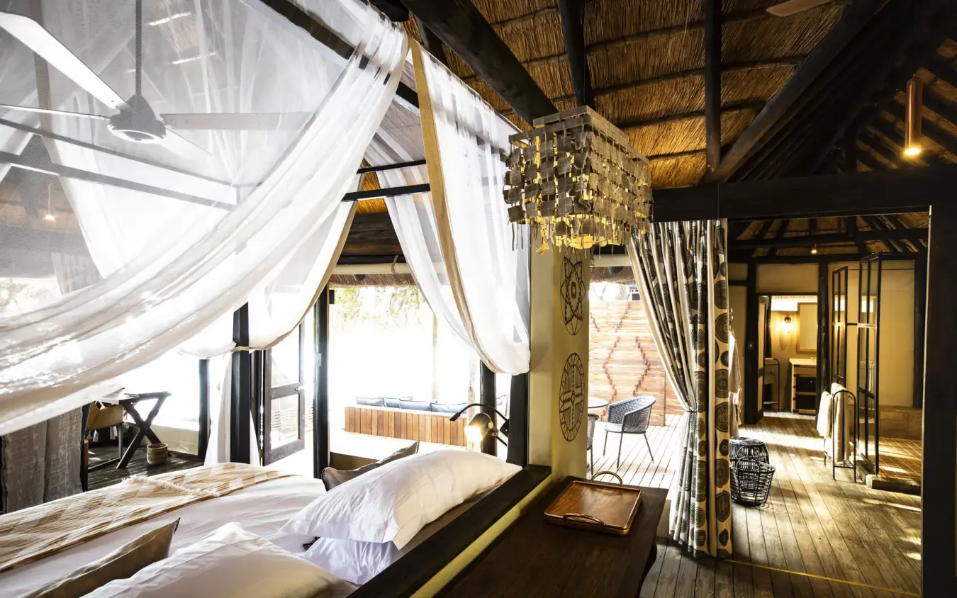 Luxury bedroom with four-poster bed and flowing white curtains, King’s Pool, Linyanti Wildlife Reserve, Botswana