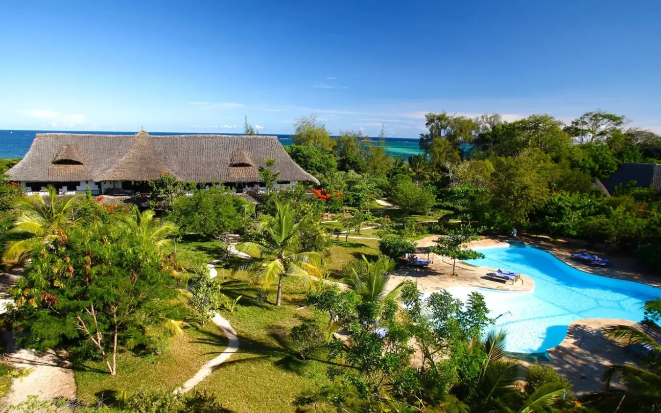 Beachfront lodge with thatched roof and turquoise pool overlooking ocean, Kinondo Kwetu, Diani Beach, Kenya