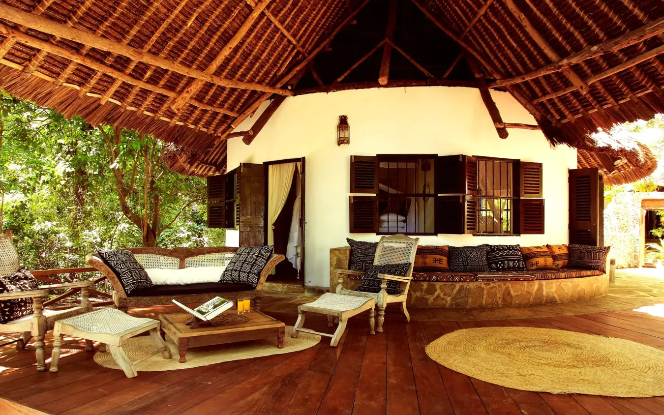 Thatched-roof lodge pavilion with wooden deck and lounge seating, Kinondo Kwetu, Diani Beach, Kenya