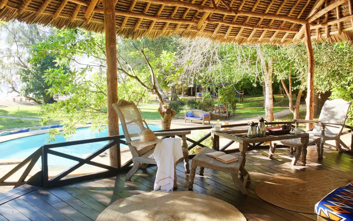 Thatched pergola with lounge seating overlooking swimming pool and gardens, Kinondo Kwetu, Diani Beach, Kenya