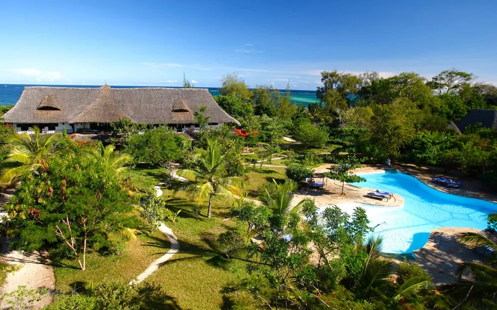 Beachfront lodge with thatched roof and pool overlooking tropical coastline, Kinondo Kwetu, Diani Beach, Kenya