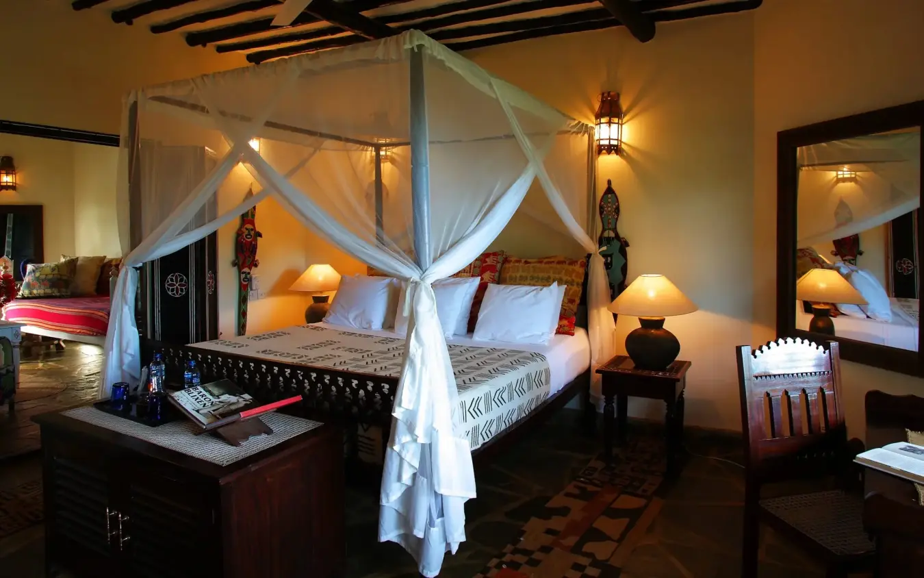 Canopy bed with sheer drapes in colonial-style bedroom suite, Kinondo Kwetu, Diani Beach, Kenya