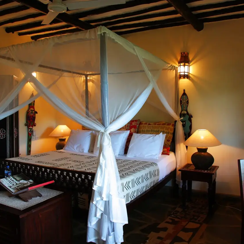 Luxury bedroom with four-poster canopy bed and ambient lighting, Kinondo Kwetu, Diani Beach, Kenya
