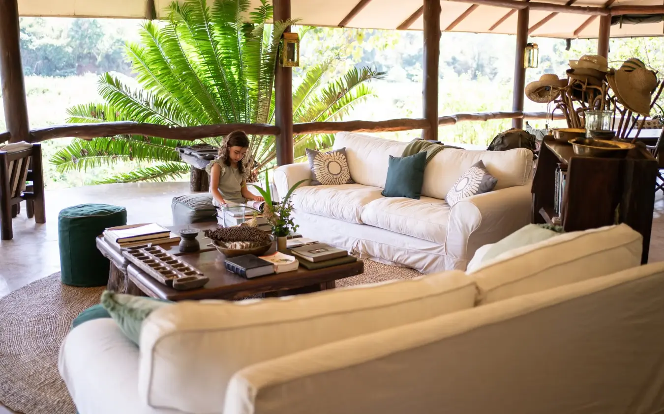 Open-air lounge with cream sofas overlooking landscape, Kitich Camp, Northern Kenya, Kenya