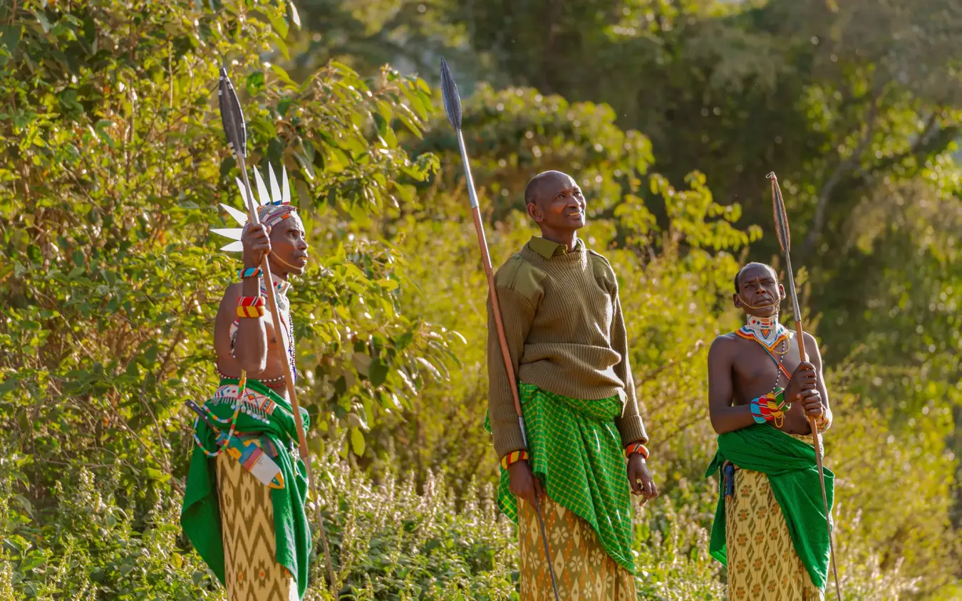 Three indigenous guides holding spears in forest setting, Kitich Camp, Northern Kenya, Kenya