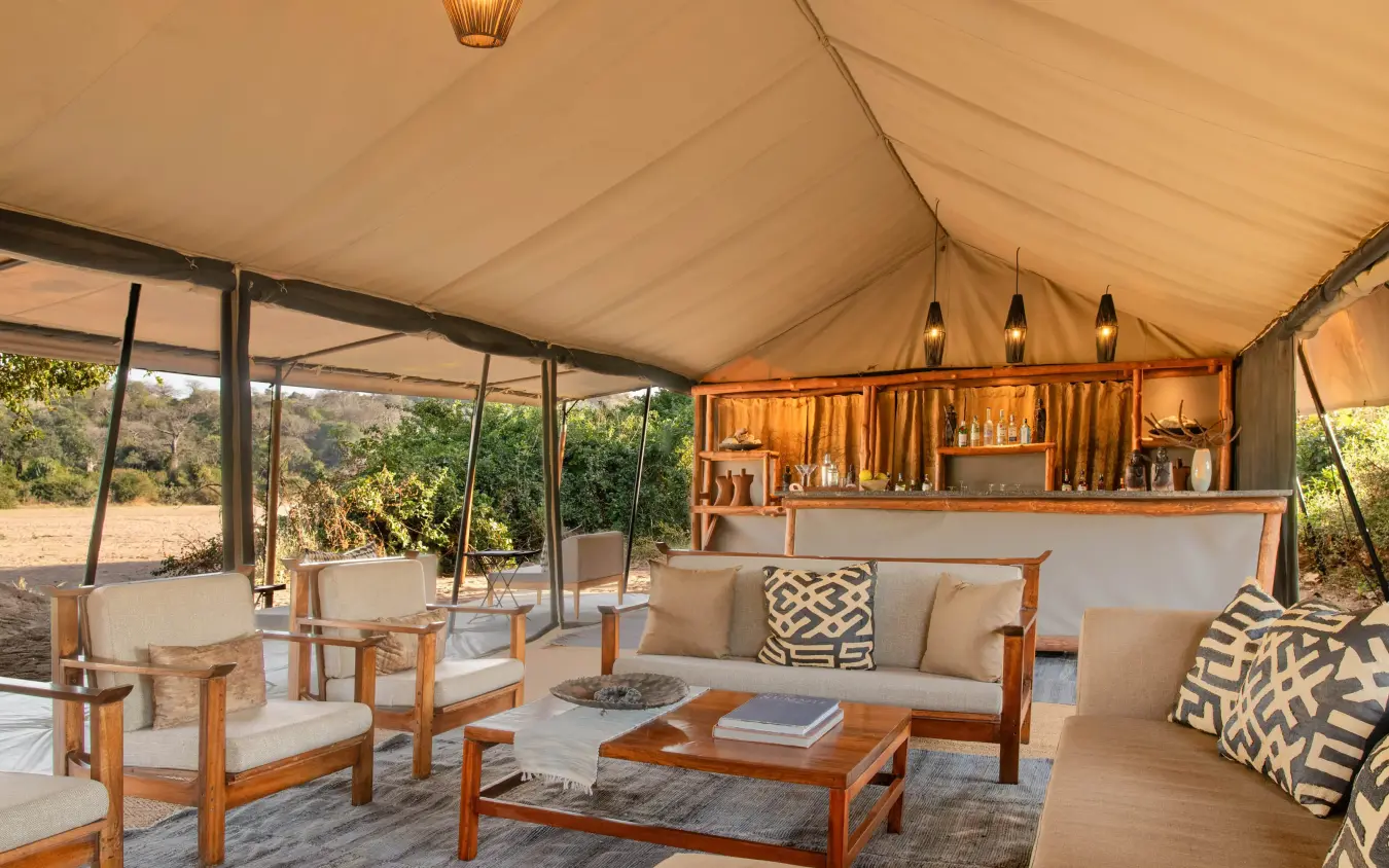 Luxury safari lounge with canvas tent, wooden furniture, Kokoko Camp, Ruaha National Park, Tanzania